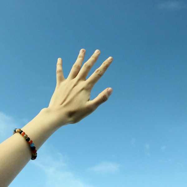 Person stretching arms towards the sky, feeling energized.